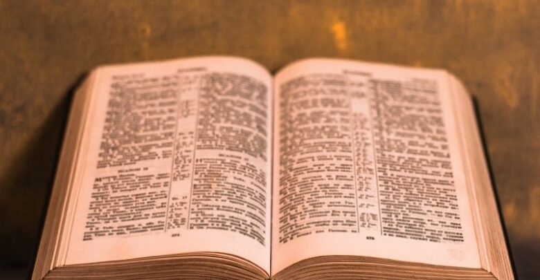 Bible-crucifix-and-beads-on-a-wooden-table.-cm