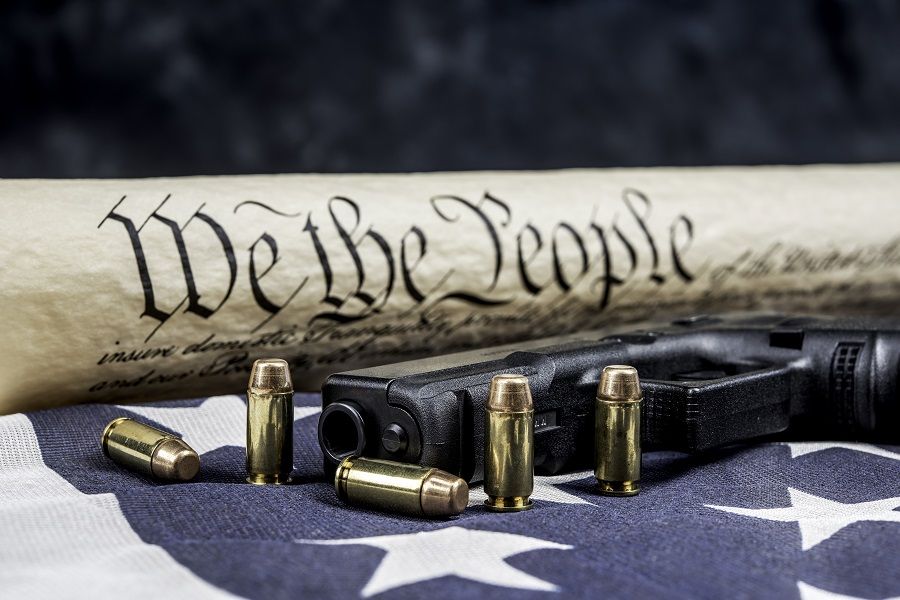 US Constitution and gun with bullets