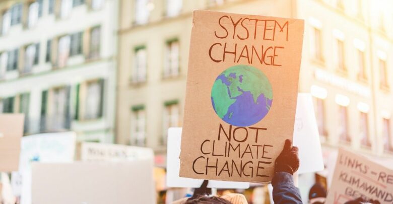 system-change-not-climate-change-sign in hands of protestor