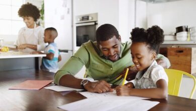 African-American-father-homeschooling-daughter-at-kitchen-table