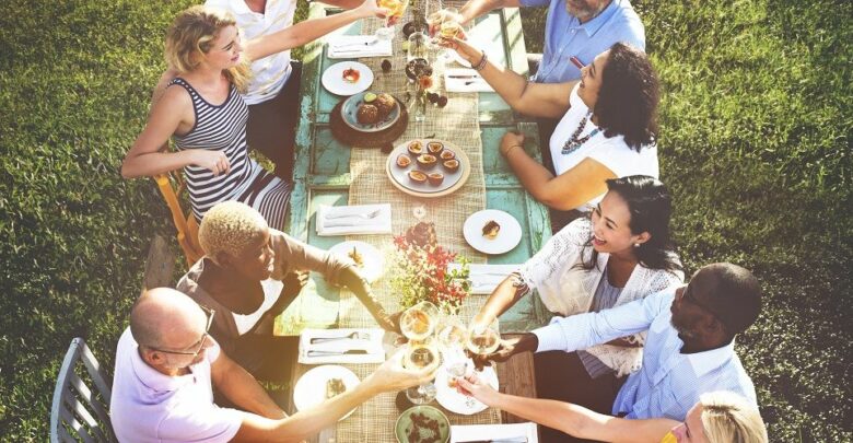 diverse group of neighbors having a meal together