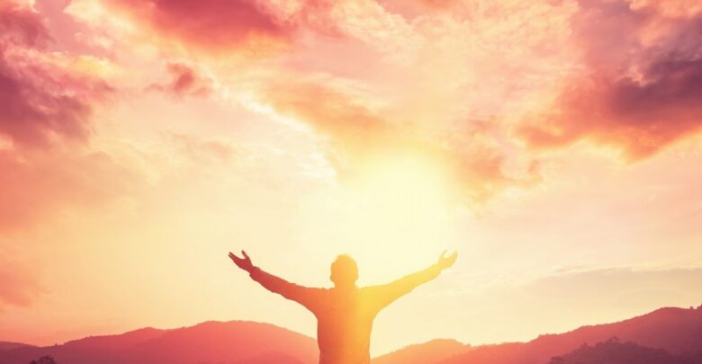 Hopeful Sunrise with Man Praising God