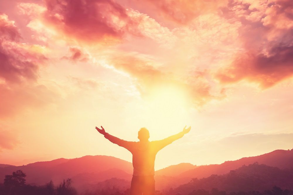 Hopeful Sunrise with Man Praising God