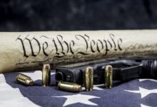 Constitution and gun with bullets defending our freedom