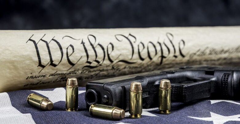 Constitution and gun with bullets defending our freedom
